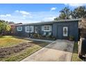 This is a charming one-story home showcasing a driveway and an attached garage, with yard at 783 Cornelia Ct, Orlando, FL 32811