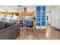 Open concept living area showcasing wood-look flooring and bright blue shelving details at 927 Buena Vista Ct, Orlando, FL 32818