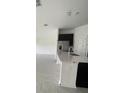 Modern kitchen features island, stainless steel appliances, and dark cabinetry at 1148 Pomelo St, Davenport, FL 33837