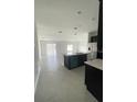 Open concept kitchen with island and view into living area at 1148 Pomelo St, Davenport, FL 33837