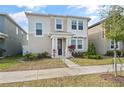 Attractive two-story home with a well-maintained lawn and garden beds at 11842 Sunsail Ave, Orlando, FL 32832