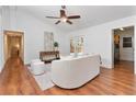 Cozy living room with wood flooring, access to the backyard, and neutral-toned furniture for relaxation and comfort at 1221 Thunder Trl, Maitland, FL 32751