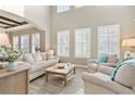 Spacious living room with large windows and high ceilings at 15138 Shonan Gold Dr, Winter Garden, FL 34787