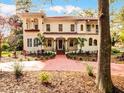 Elegant home with a terra cotta tile roof, arched details, and a walkway leading to a covered front porch at 2004 Magnolia Ave, Sanford, FL 32771