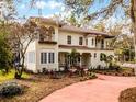 Stately two-story residence with a terra cotta tile roof, complemented by a walkway and mature landscaping at 2004 Magnolia Ave, Sanford, FL 32771