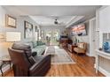 Inviting living room with comfortable seating, wood floors, and bright light from the backyard at 204 E South St # 2052, Orlando, FL 32801