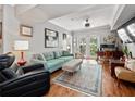 Cozy living room with blue couch, ottoman, area rug, and a french door at 204 E South St # 2052, Orlando, FL 32801