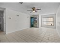 Spacious living area with tile floors, a ceiling fan, and neutral wall colors at 208 Diamond Cv # 104, Casselberry, FL 32707