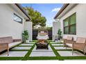 Relaxing patio with firepit, seating area, and artificial turf at 2309 Depauw Ave, Orlando, FL 32804