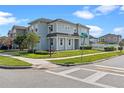 Two-story home with light blue siding, landscaping, and street corner at 2464 Rapollo Dr, Kissimmee, FL 34741