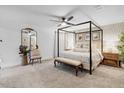 Main bedroom with canopy bed, sitting area, and patterned wallpaper at 275 Sunfish Dr, Winter Haven, FL 33881