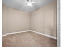 Condo bedroom with carpeted floor and ceiling fan at 2801 S Ridgewood Ave # 807, South Daytona, FL 32119
