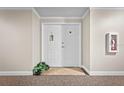Condo entry with double doors,plant,and fire extinguisher at 2801 S Ridgewood Ave # 807, South Daytona, FL 32119