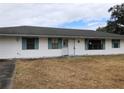Ranch style home with white siding and teal shutters at 34847 Learn Rd, Leesburg, FL 34788