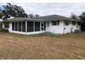 Rear view of a home with a screened porch at 34847 Learn Rd, Leesburg, FL 34788