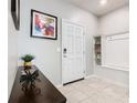 Bright entryway with tile flooring, coat bench, and modern decor at 3798 Lana Ave, Davenport, FL 33897