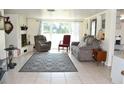Living room with a large rug, fireplace and a large window for natural light at 423 Longfellow Blvd, Lakeland, FL 33801