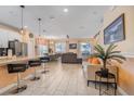 Open concept living area with modern tile floors, breakfast bar, neutral walls, and dining area at 4800 Memories Ln, Kissimmee, FL 34746