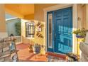Close up of a vibrant blue front door that is framed with decorative foliage at 4912 Atwood Dr, Orlando, FL 32828