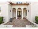 Elegant entry with arched columns, tile accents, and a double door at 506 Yellow Submarine Ct, Groveland, FL 34737