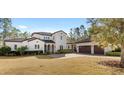 Stunning two-story house with tile roof, landscaping, and a three-car garage at 506 Yellow Submarine Ct, Groveland, FL 34737