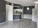 Open living area with modern flooring, neutral paint, and a view into the kitchen at 5518 Metrowest Blvd # 104, Orlando, FL 32811