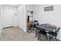 Small condo foyer with table, closet, and shoe rack at 6102 Curry Ford Rd # 202, Orlando, FL 32822