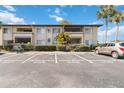 Exterior view of building with parking spaces and a car at 6102 Curry Ford Rd # 202, Orlando, FL 32822