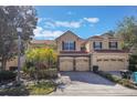 Charming townhome featuring a two-car garage, stone accents and a well manicured lawn at 7189 Regina Way, Orlando, FL 32819