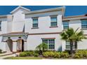 Charming two-story home with tan trim, brown tile roof, and a neatly landscaped front yard at 9023 Dogleg Dr, Davenport, FL 33896