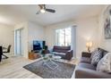 A bright living room features stylish sofas, a modern glass coffee table and sliding glass door at 9023 Dogleg Dr, Davenport, FL 33896