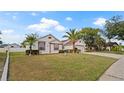 Well-maintained single Gathering home with lush green lawn and driveway leading to an attached two-car garage at 9664 Lake Douglas Pl, Orlando, FL 32817