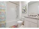 Bathroom with white tub, shower, vanity, and granite countertop at 1273 Limbali St, Mount Dora, FL 32757