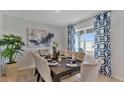 Bright dining room featuring a wooden table and blue accents at 1281 Limbali St, Mount Dora, FL 32757