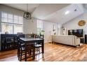 Open-concept living space with wood flooring, dining table, and neutral decor at 1341 Arbor Vista Loop # 321, Lake Mary, FL 32746