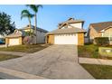 Charming two-story home featuring a two-car garage, brick accents, mature landscaping, and a well-maintained lawn at 14607 Traders Path, Orlando, FL 32837