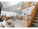 Spacious living room featuring high ceilings, tile floors, and a staircase leading to the upper level at 14607 Traders Path, Orlando, FL 32837