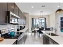 Modern kitchen features stainless steel appliances and ample counter space at 153 Villa Domani Cir, Davenport, FL 33896