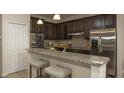 Modern kitchen with granite countertops and stainless steel appliances at 1575 Weaver Oak Way, Deland, FL 32720