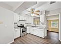 Bright kitchen features stainless steel appliances, white cabinets, and modern countertops at 2049 Jefferson Ave, Deltona, FL 32738