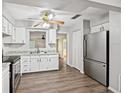 Bright kitchen features stainless steel appliances, white cabinets, and modern countertops at 2049 Jefferson Ave, Deltona, FL 32738