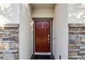 Red front door with stone accents at 2089 Camden Loop, Davenport, FL 33837