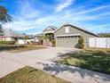 House exterior with a driveway and landscaped lawn at 3291 Pawleys N Loop, St Cloud, FL 34769