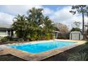 Refreshing blue rectangular pool, surrounded by lush greenery at 3458 Balsam Dr, Winter Park, FL 32792