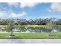 Scenic view of a lake with lush green grass and trees at 4298 Campsite Loop, Orlando, FL 32824