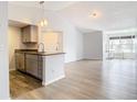 Modern condo kitchen with stainless steel appliances and light gray cabinets at 5144 Conroy Rd # 35, Orlando, FL 32811