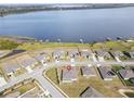 A beautiful aerial view of a home near a stunning lake with docks, offering a serene waterfront living experience at 530 Sanctuary Blvd, Winter Haven, FL 33881