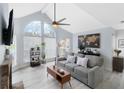 Bright living room with vaulted ceiling, fireplace and gray couch at 625 Greencove Ter # 123, Altamonte Springs, FL 32714
