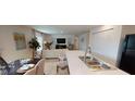 Modern kitchen island with breakfast bar overlooks dining area at 649 E Howry Ave, Deland, FL 32724