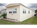 Home exterior features a modern design with clean lines and mature landscaping at 662 Sinclair Cir, Tavares, FL 32778
